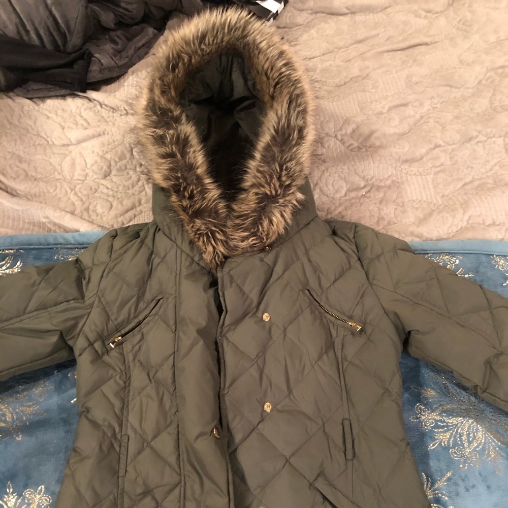 Woman’s winter jacket with faux fur hood